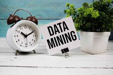 Data Mining text written on paper card with alarm clock on wooden background 写真素材