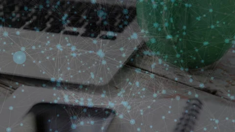 Data network flowing across silver laptop keyboard and smartphone on Video stock 307446069