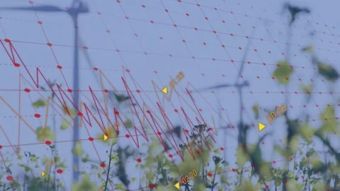 Data overlay appearing graph animating across turbines yellow flowers swaying Stock-Footage 334040748