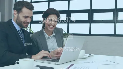 Data overlay appearing, man typing and woman pointing at laptop, reviewing Stock Footage 335739306