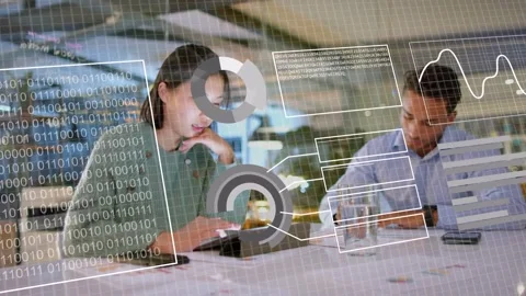 Data overlay appearing over tablet, woman tapping and man writing while Stock Footage 333837312