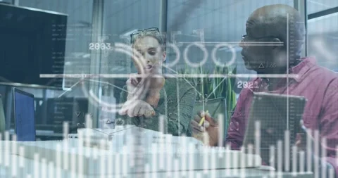 Data overlays appearing on office table leading architects tracing scale model Stock Footage 317155851