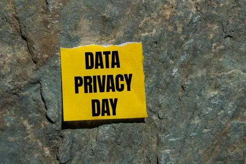 Data privacy day message written on ripped torn yellow paper piece with sto.. Stock Photos