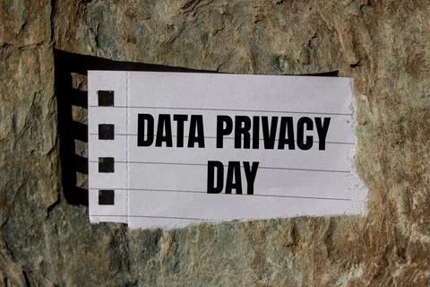 Data privacy day message written on ripped torn paper piece with stone back.. Stock Photos