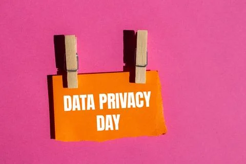 Data privacy day message written on ripped torn orange paper piece with pin.. Stock Photos