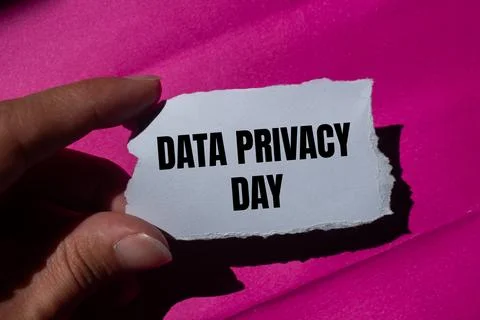 Data privacy day message written on ripped torn paper piece with a pink bac.. Stock Photos