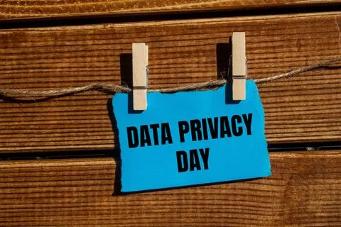 Data privacy day message written on ripped blue torn paper piece with woode.. Stock Photos