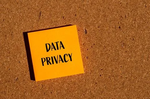 Data privacy words written on orange paper sticker with brown background Stock Photos