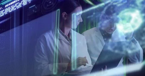 Data processing against diverse male and female engineers using laptop at Stock Photos