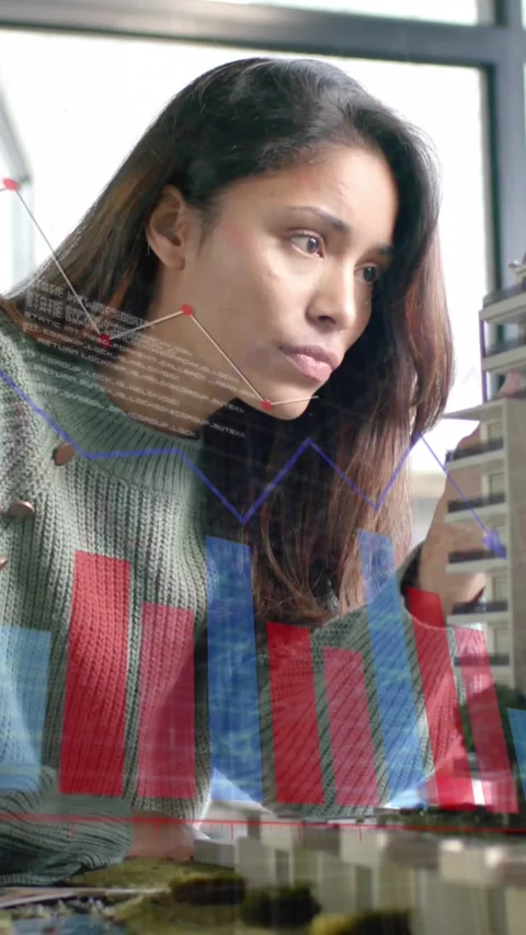 Data processing on graph over female architect studying building model Stock Footage 323782905