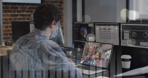 Data processing over caucasian man wearing a face mask having a video call on Stock Footage 329427461