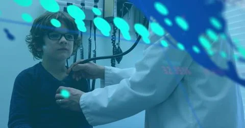Data processing over world map against asian male doctor examining caucasian boy Foto stock