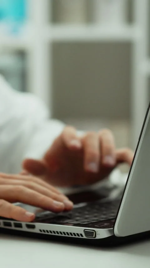 Data processing process doctor works sitting at laptop he enters digital dat Stock Footage 331541598
