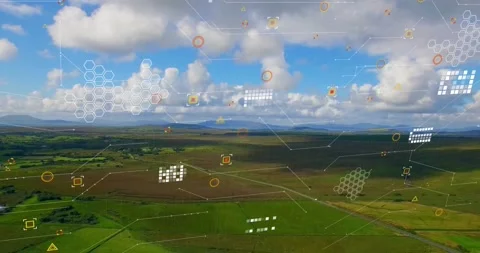 Data pulse sending translucent overlays across aerial farmland, hexagons and Stock Footage 322204524