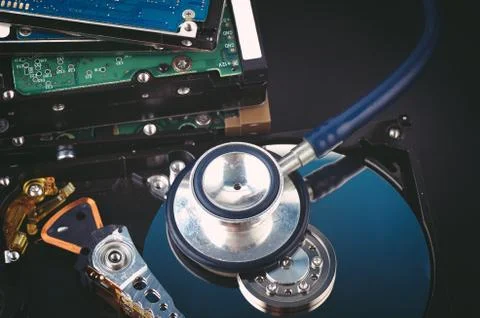Data recovery or computer forensics concept, stethoscope dusty dismantle hard Stock Photos