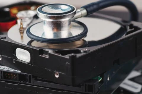 Data recovery or computer forensics concept, stethoscope dusty dismantle hard Stock Photos
