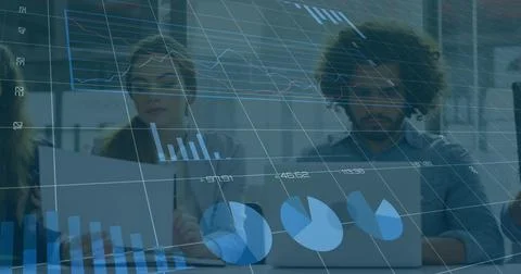 On data refresh colleagues typing on laptops while translucent 3D charts Foto stock