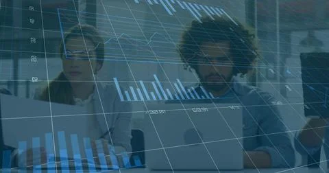 On data refresh colleagues typing on laptops while translucent 3D charts Foto stock