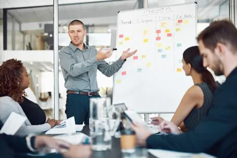 Data review, colleagues with chart and planning in a business meeting of their Stock Photos