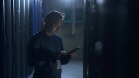 Data science engineer working with tablet and doing equipment diagnostics at big Stock Footage 163816511