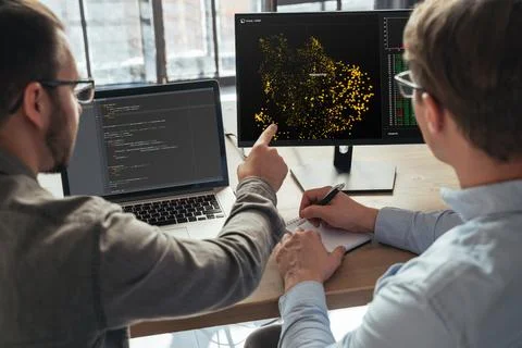 Data science specialists working at office together 库存照片