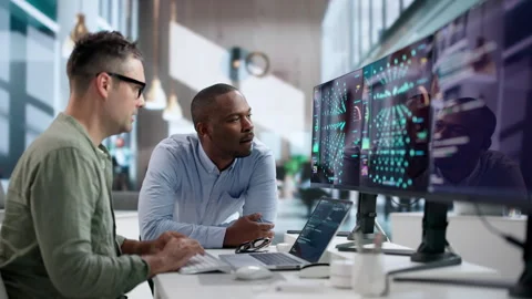 Data Scientist And Engineer Analyzing AI Models On Laptop Computers Stock Footage 346321411