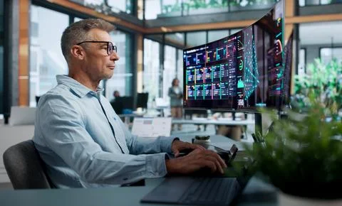 Data Scientist Carefully Analyzes Neural Network Models Using Dual Touchscree Stock Photos