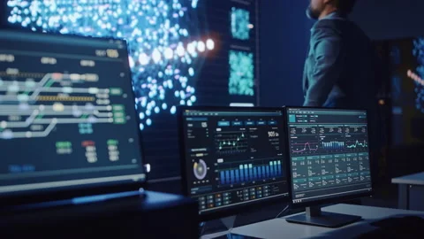 Data Scientist Looks at Global Map Chart on Big Display Stock Footage 135971196