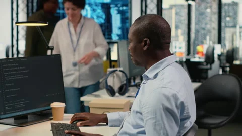 Data scientist in office automates workflows using artificial intelligence on PC Stock Footage 323029462