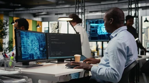 Data scientist in office automates workflows using artificial intelligence on PC Stock Footage 323238758