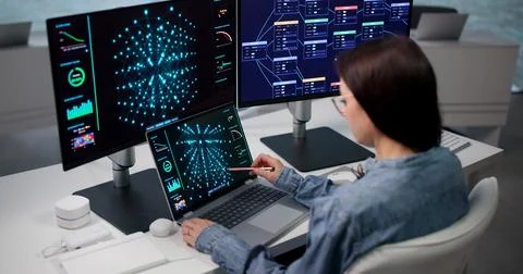 Data Scientist Reviews Machine Learning Model With Collaborative Team Laptop. Фото