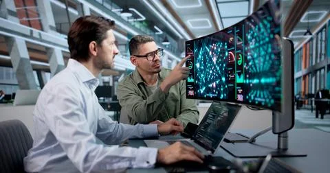 Data Scientist Reviews Predictive Models Using AI Tools On Laptop Screen. Stock Photos