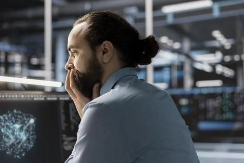 Data scientist in server room reviewing software algorithms using neural network Stockfoto's