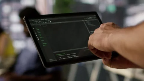 Data scientist uses tablet to check on machine learning models, close up Stock Footage 318159352