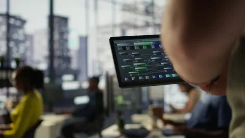 Data scientist uses tablet to check on machine learning models, close up Stock Footage 318232985