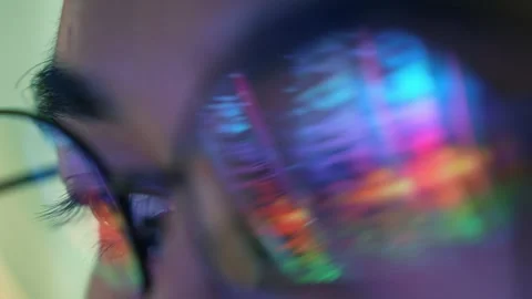 A data scientist wearing glasses studies a digital analytics dashboard Stock Footage 341663322