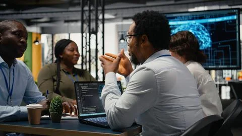 Data scientists in startup office brainstorming leveraging AI tech Stock Photos