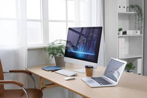 Data scientist's workplace with computer and diagrams in office Stock Photos