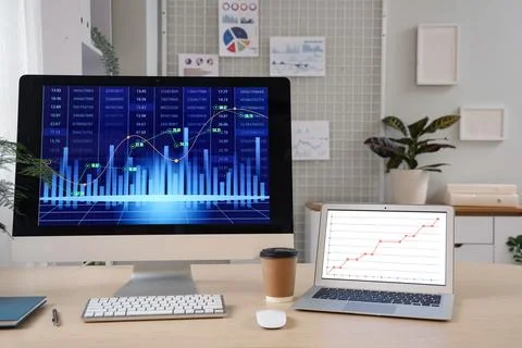 Data scientist's workplace with computer and diagrams in office Stock Photos