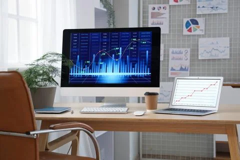 Data scientist's workplace with computer and diagrams in office Stock Photos