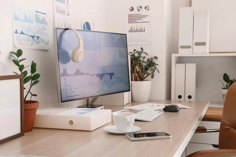 Data scientist's workplace with computer and diagrams in office Foto stock