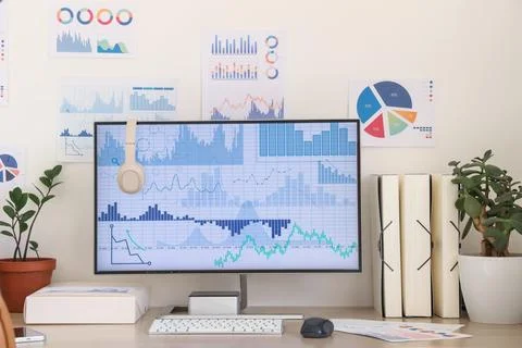 Data scientist's workplace with computer and diagrams in office 写真素材