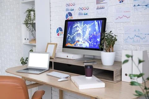 Data scientist's workplace with computer and diagrams in office Stock Photos