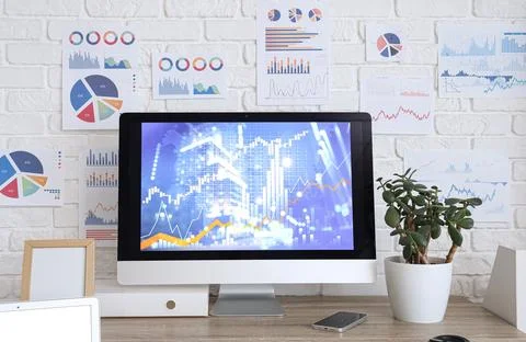 Data scientist's workplace with computer and diagrams in office Foto stock