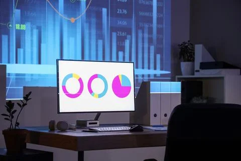 Data scientist's workplace with computer in dark office Stock Photos