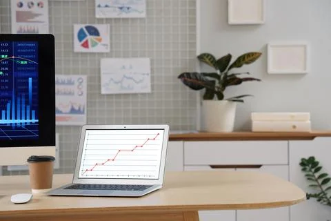 Data scientist's workplace with laptop and diagrams in office Stock Photos