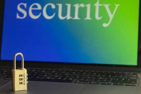Data security padlock on laptop keyboard with screen background Stock Photos