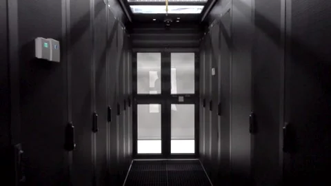 Data servers behind glass panels in the server room of a data center or ISP Stock Footage 169477811