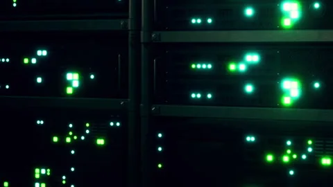 Data servers with blinking lights in a tech facility during nighttime hours Stock Footage 345005960