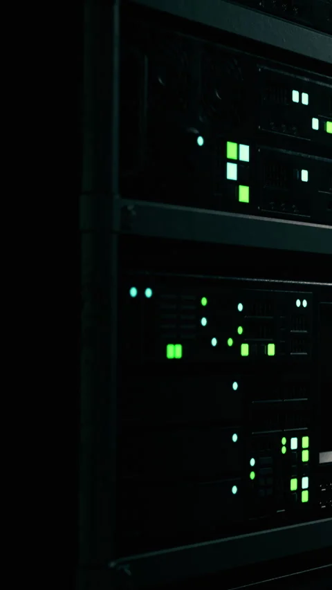 Data servers glow in dark room with green light indicators Stock Footage 338388455